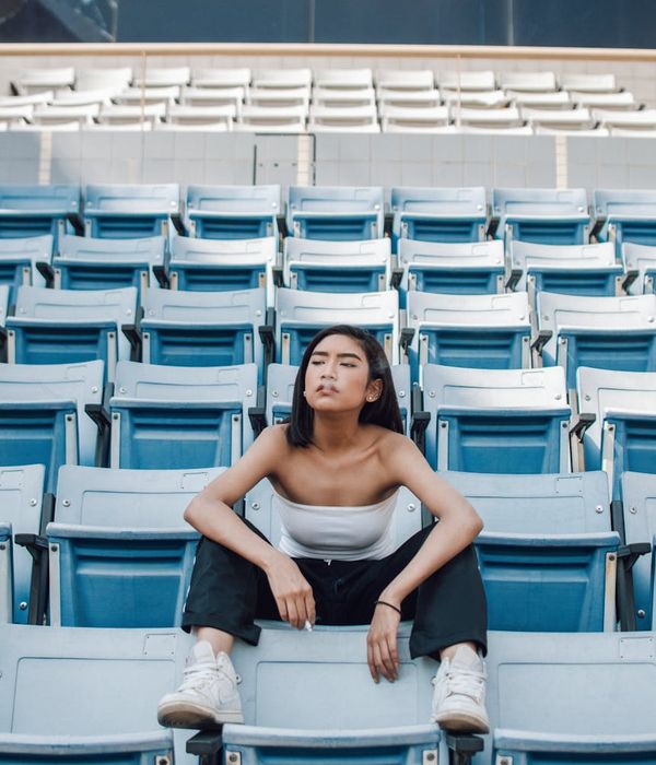 Woman feeling energized and balanced in a bright, modern space.